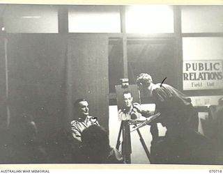 PORT MORESBY, PAPUA, NEW GUINEA, 1944-02-02. VX93433 CAPTAIN W.A. DARGIE (1), OFFICIAL WAR ARTIST, MILITARY HISTORY SECTION, LECTURING AND DEMONSTRATING PORTRAIT PAINTING USING QX27970 SERGEANT W. ..
