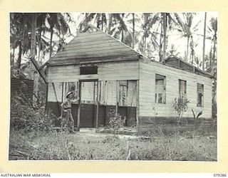 KALAI PLANTATION, HENRY REID BAY, NEW BRITAIN. 1945-02-17. THIS DAMAGED BUILDING IN THE PLANTATION WAS USED AS A TEMPORARY HOSPITAL FOR PERSONNEL WOUNDED IN THE TIL SHOOTINGS