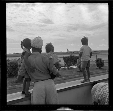 Locals watching Fiji Airways aeroplane, VQ-FAY, at Nadi Airport, Fiji