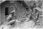 Eating ritual pork in front of men's house