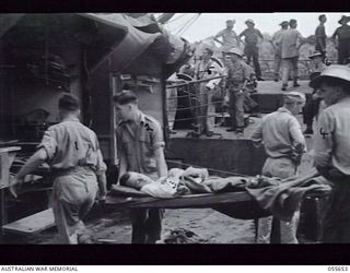 NEW GUINEA. 1943-07-28. AUSTRALIAN WOUNDED FROM NASSAU BAY BEING TAKEN OFF THE TUNGSIN. STRETCHER BEARERS OF THE 10TH AUSTRALIAN FIELD AMBULANCE ARE DRIVER (DR) K. FLINTOFT (1); PRIVATE BETH (2); ..