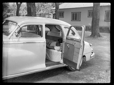 [Plymouth?] car, taxi, man at back seat resting, Papeete, Tahiti