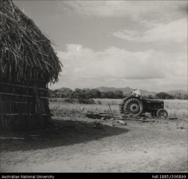 Farmer riding tractor