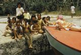 Federated States of Micronesia, group of children relaxing at waterfront in Chuuk State