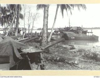 ALEXISHAFEN, NEW GUINEA. 1944-05-26. SUPPLIES FOR THE 8TH INFANTRY BRIGADE AT AN UNLOADING POINT FOR SHIPPING