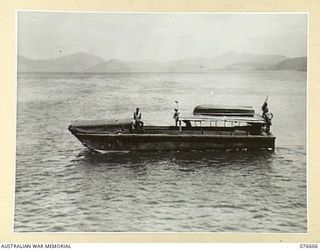 PORT MORESBY, PAPUA. 1944-10-21. ALC (AUSTRALIAN LANDING CRAFT) 5-AB 1004 OF THE 55TH PORT CRAFT COMPANY, SHOWING LOCAL MODIFICATIONS TO THE VESSEL, INCLUDING CANOPIES FORE AND AFT, NAVIGATION ..