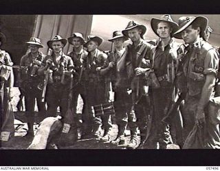 NADZAB, NEW GUINEA. 1943-09-20. MEN OF THE 2/16TH BATTALION, 21ST AUSTRALIAN BRIGADE, WAITING TO EMPLANE AT NO. 1 AIRSTRIP. LEFT TO RIGHT: WX5695 CORPORAL A. J. HARDISTY; NX153333 PRIVATE (PTE) T. ..