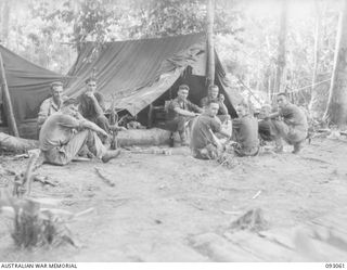WEWAK AREA, NEW GUINEA, 1945-06-11. A GROUP OF 2/8 INFANTRY BATTALION SIGNALLERS TAKEN OUTSIDE THE SIGNAL OFFICE ON 770 FOOT FEATURE. IDENTIFIED PERSONNEL ARE:- PTE A.S. COOK (1); PTE L. LANE (2); ..