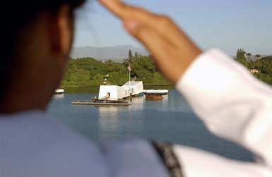 A US Navy (USN) Sailor mans the rails and renders honor to the Battleship ARIZONA (BB 39) Memorial as the Nimitz Class Aircraft Carrier USS RONALD REAGAN (CVN 76) pulls into Naval Station (NS) Pearl Harbor, Hawaii (HI). The REAGAN's first port visit to Hawaii comes in support of Operation UNIFIED ASSISTANCE, the humanitarian operation effort in the wake of the Tsunami that struck South East Asia on December 26, 2004