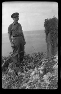 [Serviceman on hill overlooking ocean]