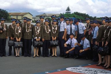 Members of the Chinese People's Liberation Army Air Force Song and Dance Troupe pose for a photograph with US Air Force personnel upon their arrival at the base. The troupe is here on the final stop of its US tour