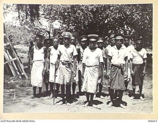RABAUL, NEW BRITAIN. 1945-09-15. FOLLOWING THE SURRENDER OF THE JAPANESE AND REOCCUPATION OF RABAUL BY AUSTRALIAN TROOPS A GROUP OF LULULAI AND TUL TULS (NATIVE OFFICIALS) FROM 26 SURROUNDING ..