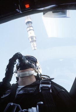 A photographer watches from the back seat of a 199th Tactical Fighter Squadron, Hawaii Air National Guard, F-4 Phantom II aircraft as it approaches the refueling boom of a 161st Air Refueling Group KC-135 Stratotanker aircraft