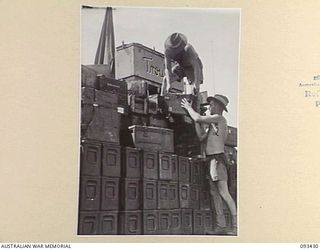 AITAPE BEACH HEAD, NEW GUINEA. 1945-06-19. SAPPER J. PERKINS (1) AND SAPPER C.G. WEBB (2), MEMBERS OF 7 DOCKS OPERATING COMPANY, ROYAL AUSTRALIAN ENGINEERS, ON BOARD LANDING CRAFT TANK BARGE, ..