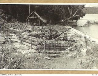 LANGEMAK BAY, NEW GUINEA. 1943-12-11. A BOFORS 40MM ANTI AIRCRAFT GUN SITE ON THE BEACH ON THE SOUTHERN SIDE OF THE BAY