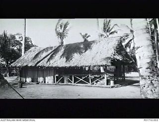 DOBODURA, NEW GUINEA. GRASS HUT USED BY MEMBERS OF NO. 1 AIR SEA RESCUE SQUADRON, RAAF, AND BUILT BY THE AUSTRALIAN NEW GUINEA ADMINISTRATIVE UNIT (ANGAU). (DONOR D. THATCHER)