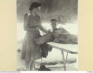 PORT MORESBY, NEW GUINEA. 1944-05-05. B2/301 SUPERINTENDENT MISS S. GRAHAM, A MEMBER OF THE AUSTRALIAN RED CROSS SOCIETY ATTACHED TO THE 2/1ST GENERAL HOSPITAL (1), HANDS NX129946 GUNNER PREE, ..