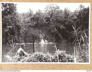 DREGER HARBOUR, NEW GUINEA. 1943-12-03. FIRST LIEUTENANT JOHN F. BOYSEN OF THE 870TH UNITED STATES AVIATION ENGINEER BATTALION PEGGING THE SITE FOR A NEW BRIDGE ACROSS THE MAPE RIVER, NEAR LANGEMAK ..