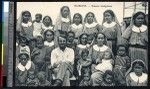 European man poses with indigenous sisters, Papua New Guinea, ca.1900-1930