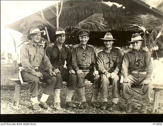 Madang, New Guinea. 1944-06-14. Senior Officers at Headquarters 15th Infantry Brigade outside a building at Siar Plantation. Left to right: VX186 Lieutenant Colonel G. R. Warfe MC, Commanding ..