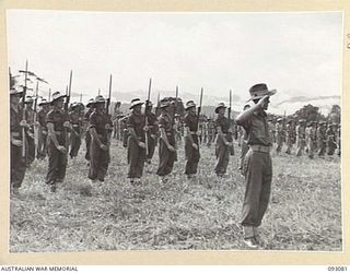 LAE AREA, NEW GUINEA, 1945-06-16. TROOPS OF 20 FIELD COMPANY, ROYAL AUSTRALIAN ENGINEERS, PRESENT ARMS FOR THE "GENERAL SALUTE" ON ARRIVAL OF LT-GEN V.A.H. STURDEE, GOC FIRST ARMY, AT A PARADE HELD ..