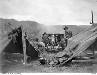 DAGUA, NEW GUINEA. 1945-03-25. ONE OF THE GUNS OF THE 2/2ND FIELD REGIMENT FIRING AT A JAPANESE POSITION IN THE AREA IN WHICH LIEUTENANT A. CHOWNE, MM, GAINED HIS VC