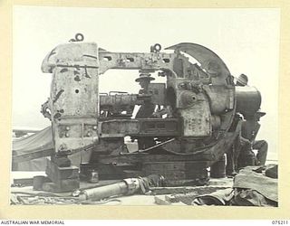 PORT MORESBY, PAPUA. 1944-08-17. GUNNERS WORKING ON THE INSTALLATION OF THE CRADLE OF NO. 1 GUN (5.25) AT THE BASILISK BATTERY, OF THE 801ST ANTI AIRCRAFT AND COAST ARTILLERY BATTERY