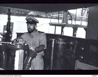 RABAUL, NEW BRITAIN, 1946-03-07. LIEUTENANT COMMANDER W.J. DOVERS, RAN, CAPTAIN OF HMAS BARCOO (K375), ON THE BRIDGE