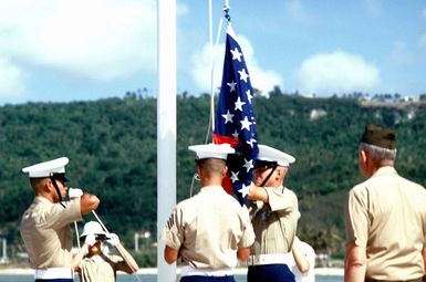 General Louis H. Wilson, Commandant of the Marine Corps, watches as Marines raise the flag during a ceremony conducted as work begins on the War in the Pacific National Park