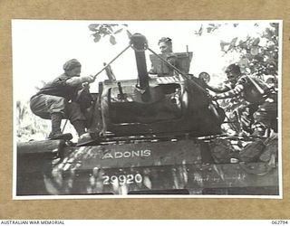 HUON PENINSULA AREA, NEW GUINEA. 1944-01-08. PERSONNEL OF "A" SQUADRON, 1ST TANK BATTALION PULLING BACK A 3" HOWITZER TO CHECK ITS RECOIL AT THE WORKSHOP AREA OF THE 209TH LIGHT AID DETACHMENT ON ..