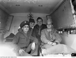 MELBOURNE, VIC. 1943-08-15. OSMAR WHITE, MELBOURNE "SUN" NEWSPAPER WAR CORRESPONDENT WITH MEMBERS OF A UNITED STATES ARMY MEDICAL UNIT IN AN AMBULANCE OUTSIDE HIS HOME AT BRIGHTON BEACH. WHITE HAD ..