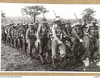 RAMU VALLEY, NEW GUINEA. 1944-01-15. PERSONNEL OF "C" COMPANY, 58/59TH INFANTRY BATTALION, 15TH INFANTRY BRIGADE MARCHING OFF FROM THE CHURCH PARADE. IDENTIFIED PERSONNEL ARE: VX102867 CORPORAL H. ..