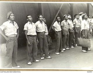 NEWCASTLE, NSW. 1944-01-28. AUSTRALIAN AND NEW GUINEA ADMINISTRATION UNIT NATIVES WATCHING A COKE FURNACE IN OPERATION AT THE BROKEN HILL PTY. WORKS