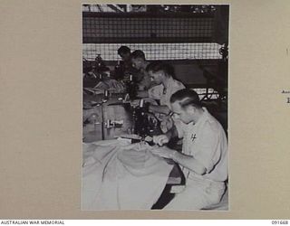 TOROKINA, BOUGAINVILLE. 1945-05-07. TAILORS AT WORK AT 4 SECTION OFFICERS' SHOP. IDENTIFIED PERSONNEL ARE:- PRIVATE J.J. GRIFFIN (1); PRIVATE L.E. PRICE (2); WARRANT OFFICER 2 J.L. TREANOR (3); ..