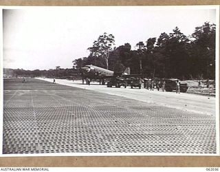 DREGER HARBOUR, NEW GUINEA. 1943-12-07. A DOUGLAS TRANSPORT IS THE FIRST LARGE AIRCRAFT TO LAND ON THE NEW STRIP BUILT BY THE 870TH UNITED STATES AVIATION BATTALION