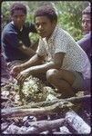 Western Highlands: people cooking bananas and other foods over an open fire pit