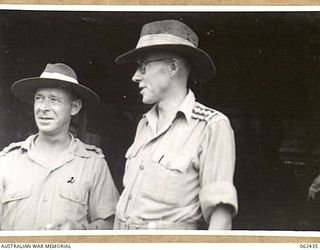 THORPVILLE, NEW GUINEA. 1943-12-08. N393145 CHAPLAIN P. AYLWARD (ROMAN CATHOLIC) (1) AND SX26741 LIEUTENANT E. R. CILENTO, PHYSIOTHERAPIST (2) OF THE 113TH AUSTRALIAN CONVALESCENT DEPOT