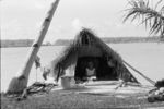 Elderly woman in her special house at lagoon shore