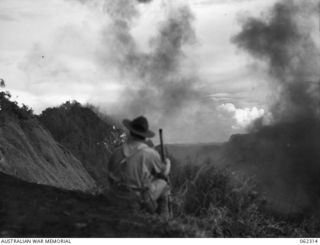 SHAGGY RIDGE, NEW GUINEA. 1943-12-27. 500 POUNDER BOMBS DROPPED FROM UNITED STATES ARMY FIGHTER AIRCRAFT EXPLODING ON JAPANESE POSITIONS ON THE "PIMPLE" DURING THE 2/16TH AUSTRALIAN INFANTRY ..