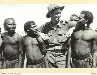 RAMU VALLEY, NEW GUINEA, 1943-10-03. VX123484 LANCE SERGEANT N.B. STUCKEY, PHOTOGRAPHER, AUSTRALIAN MILITARY HISTORY SECTION, WITH SOME BENA NATIVE CARRIERS