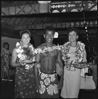 Miss Maglia, on right, and unidentified woman posing with Fijian man, Suva, Fiji, 22 February 1966 / John Mulligan