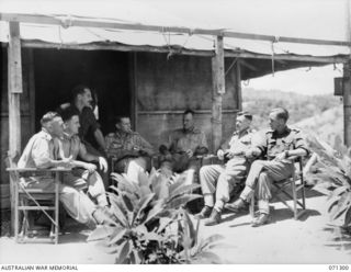 PORT MORESBY, PAPUA, 1944-03-21. OFFICERS OF THE 2/102ND GENERAL TRANSPORT COMPANY PICTURED OUTSIDE THEIR MESS HUT. IDENTIFIED PERSONNEL ARE: NX27310 LIEUTENANT K.G. CAMPBELL (1); N53447 LIEUTENANT ..