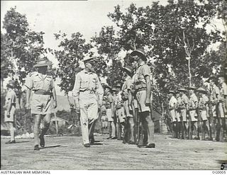 BUNA, NEW GUINEA. C. 1943. THE COMMANDING GENERAL, ALLIED AIR FORCE IN NEW GUINEA, BRIGADIER GENERAL ENNIS C. WHITEHEAD, INSPECTS RAAF TROOPS ON PARADE FOR THE CEREMONY AT WHICH FOUR RAAF OFFICERS ..