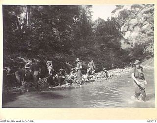 WIHIBI RIVER, NEW GUINEA. 1945-08-04. MEMBERS OF D COMPANY, 2/7 INFANTRY BATTALION, RESTING AT THE WIHIBI RIVER, WHILE ON A PATROL INTO ENEMY TERRITORY. THIS IS THE FIRST LEG OF THEIR LONG TREK TO ..