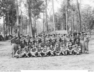 Group portrait of Non Commission Officers (NCOs) of 58/59 Infantry Battalion. Identified, back row, left to right: Sergeant (Sgt) M E Emmett; Staff Sergeant J A Davey; Sgt L Lyle; Sgt R R Gray; Sgt ..