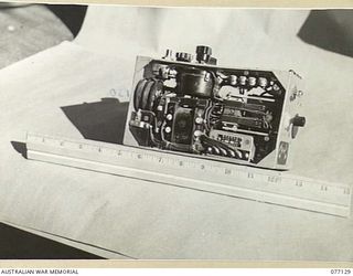 LAE AREA, NEW GUINEA. 1944-11-27. THE INNER MECHANISM (FRONT) OF A CAPTURED JAPANESE TYPE 94 MK VI "WALKIE-TALKIE" RADIO SET IN THE MUSEUM OF THE ASSISTANT QUARTERMASTER GENERAL (E) 1ST AUSTRALIAN ..