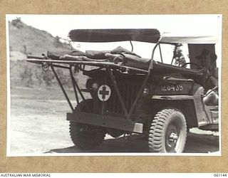 12 MILE, PORT MORESBY AREA, NEW GUINEA. 1943-12-03. NX139809 DRIVER A. F. WEATHERALL OF THE 2ND AUSTRALIAN MOTOR AMBULANCE CONVOY DEMONSTRATING A NEW JEEP AMBULANCE WHICH WAS BUILT BY THE UNIT