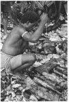 Larikeni of Furingudu measuring out kofu shell money to purchase packets of fish at market with sea people