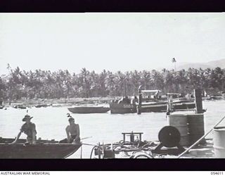 MILNE BAY, NEW GUINEA. 1943-07-11. VX106448 SAPPER (SPR) L. NOBLE (LEFT) AND V295539 SPR R. A. J. BEERS OF THE 4TH AUSTRALIAN FIELD COMPANY, ROYAL AUSTRALIAN ENGINEERS, AIF, WHO ARE EMPLOYED ON THE ..