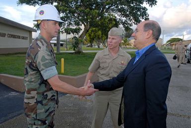 The Honorable Dr. Donald C. Winter (right), Secretary of the U.S. Navy (SECNAV), shakes hands with LT. CMDR. Scott Loeschke, Executive Officer, Naval Mobile Construction Battalion 40, during a meet and greet breakfast at Camp Covington Galley onboard Naval Base Guam on Aug. 25, 2006. The Seabees are currently deployed to Guam. They also have detachments deployed in Iraq and Afghanistan. (U.S. Navy photo by Mass Communication SPECIALIST 2nd Class John F. Looney) (Released)